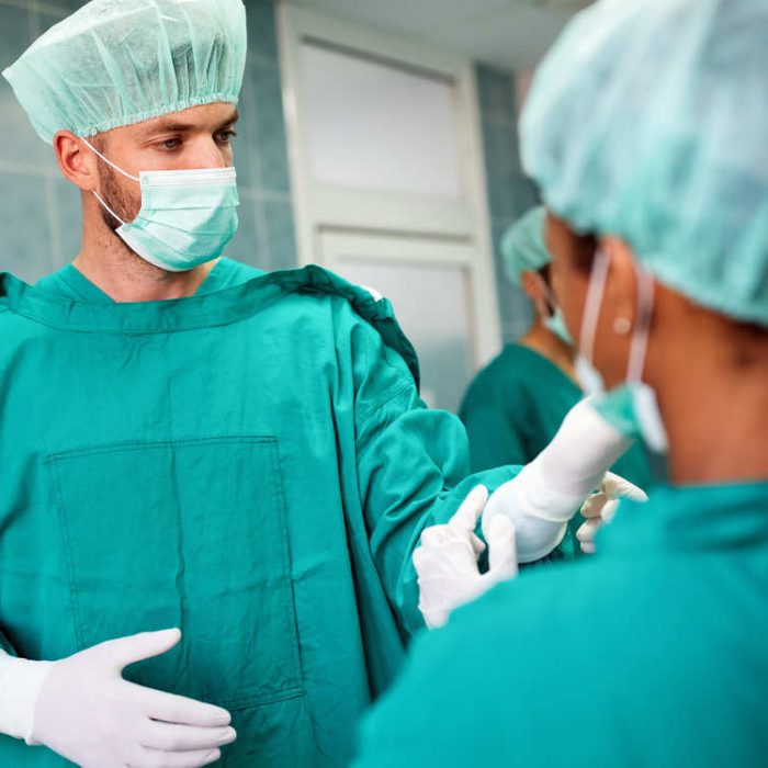 team-of-surgeons-in-the-operating-room-preparing-f-FJ4U2UD